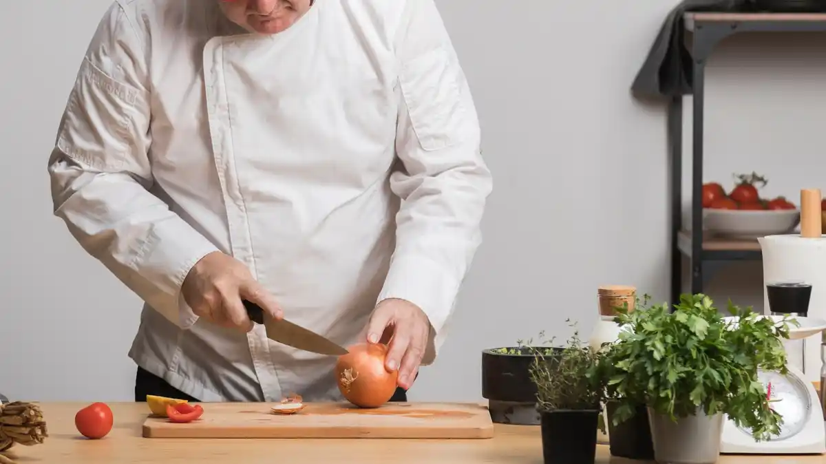 professional chef cutting vegetables with knife