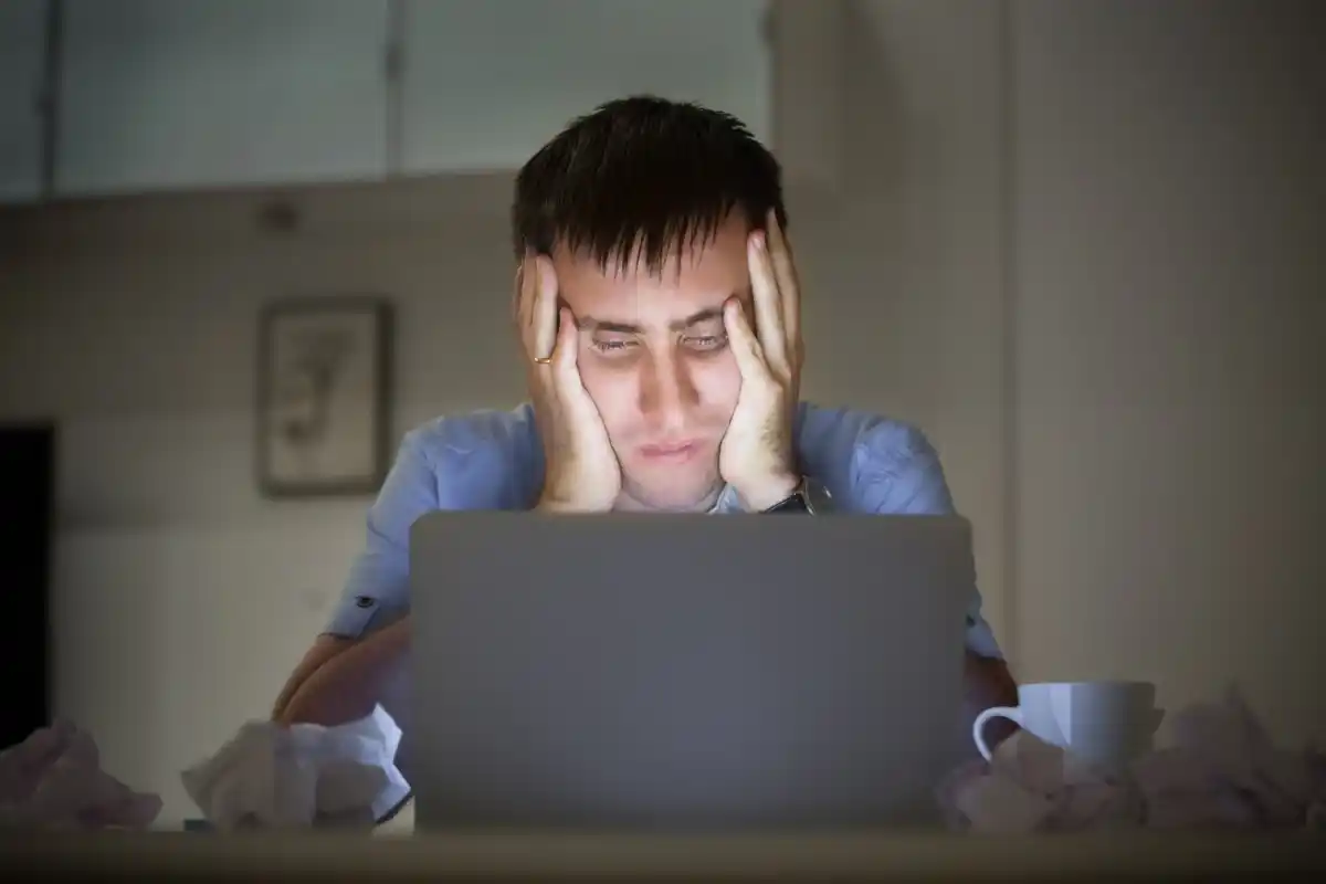 frustrated person with technology devices troubleshooting