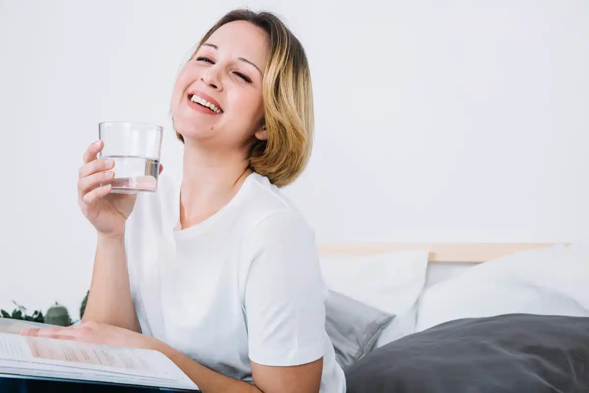 person drinking water feeling refreshed